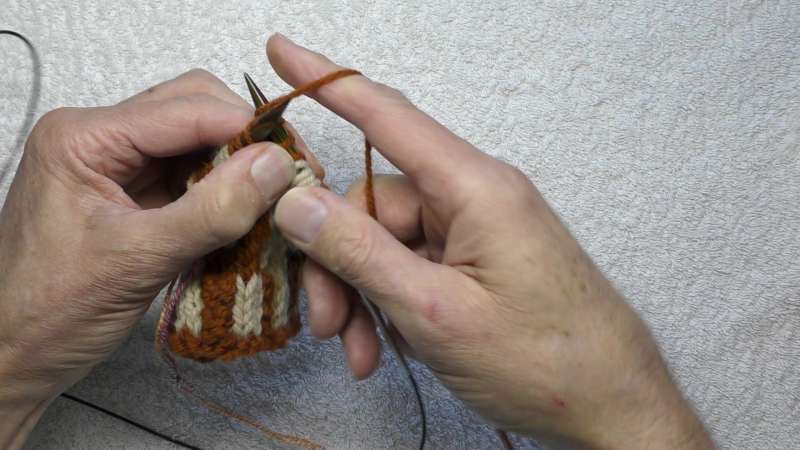 Knit into the back of the last stitch before the steek